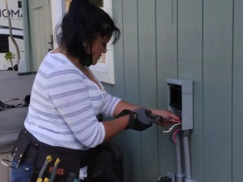 Licensed electrician wiring an exterior subpanel in Fort Polk South